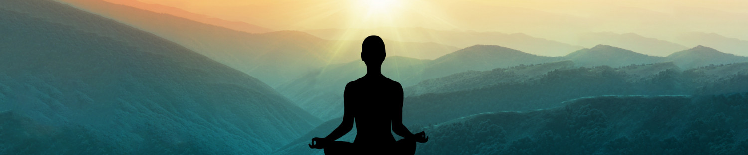 mountain with sunset and cutout of woman meditating