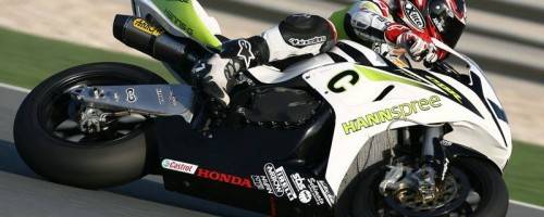 photo of motorcyclist racing, taking a turn